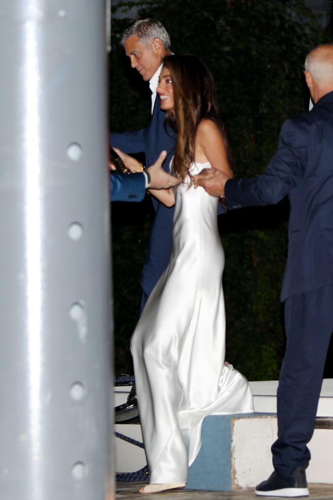 Amal Clooney in white bridal dress with George Clooney in Lake Como