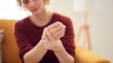 A woman holding her wrists