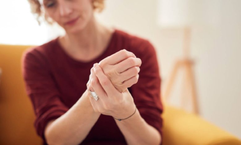 A woman holding her wrists