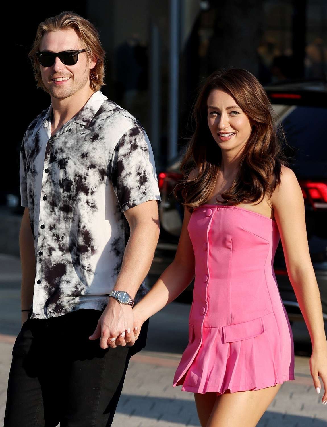 Dallas Cowboys Cheerleader Kelcey Wetterberg looks amazing in PrettyLittleThing's hot pink pleat skort romper while out with her fiance Nate Crnkovich at Mesero in Legacy West, 