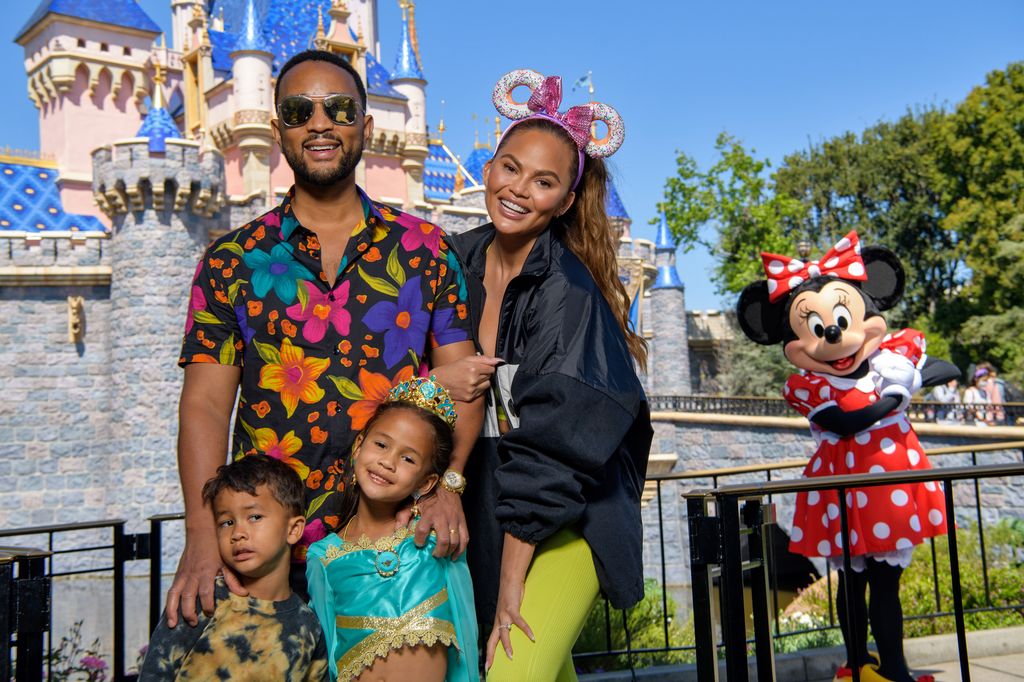 John Legend, Chrissy Teigen and their children, Miles and Luna pose with Minnie Mouse