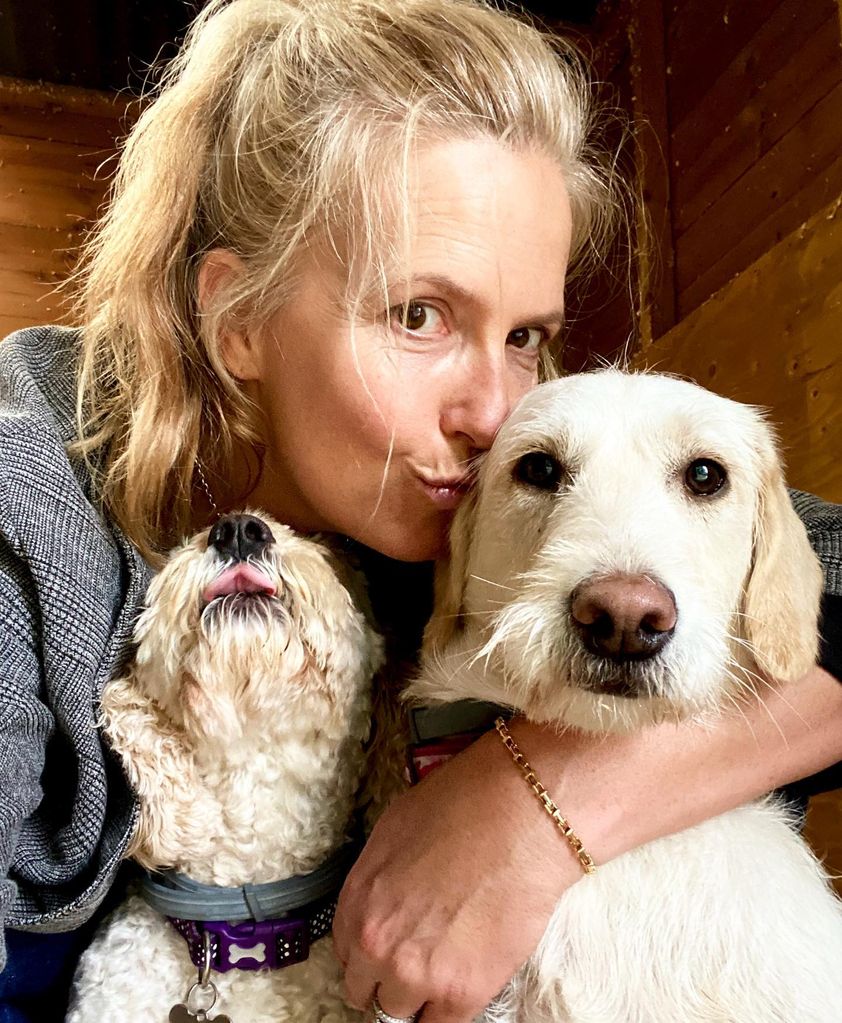 penny lancaster posing with two dogs