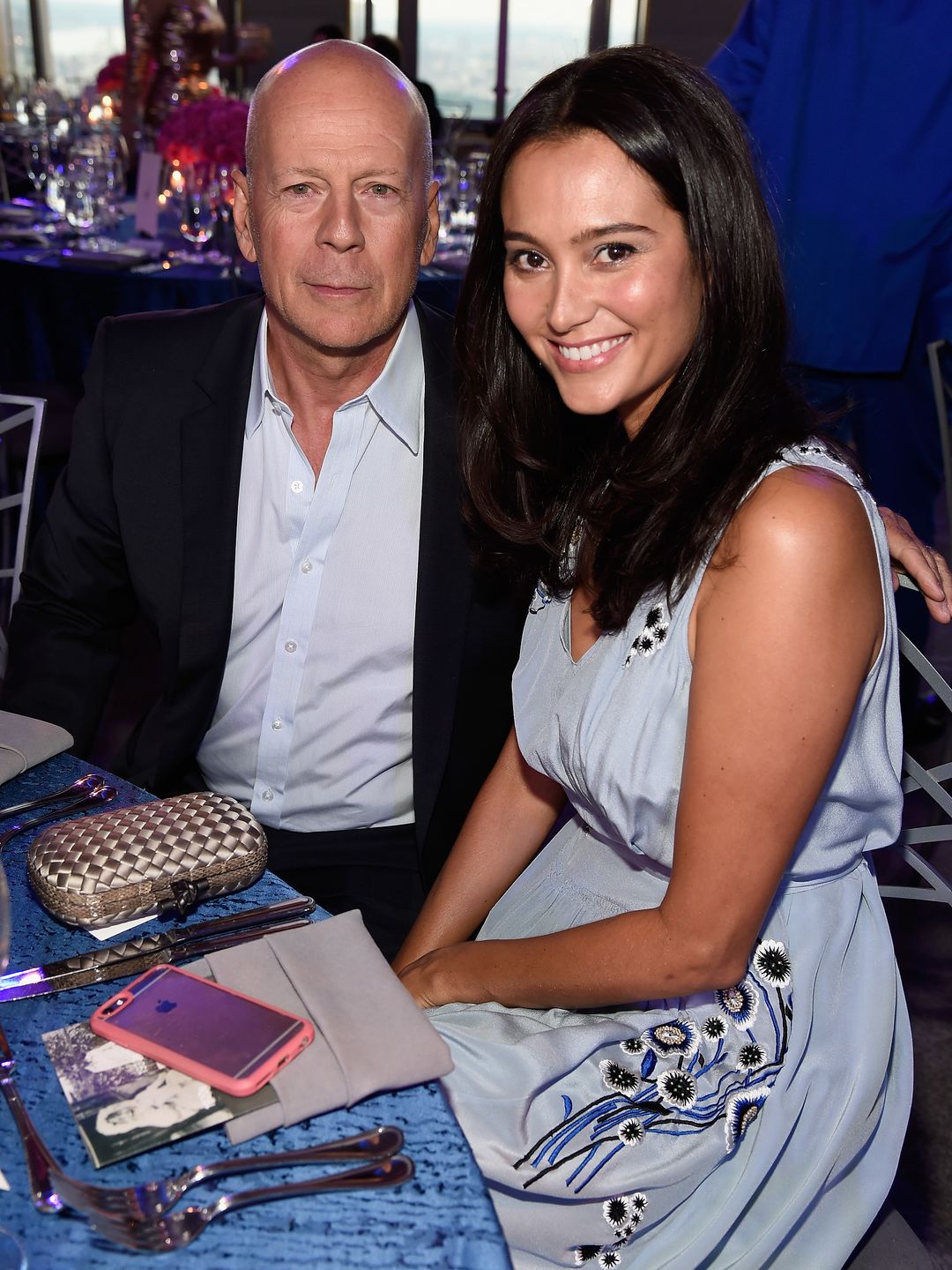 Bruce and Emma sat smiling together at an event