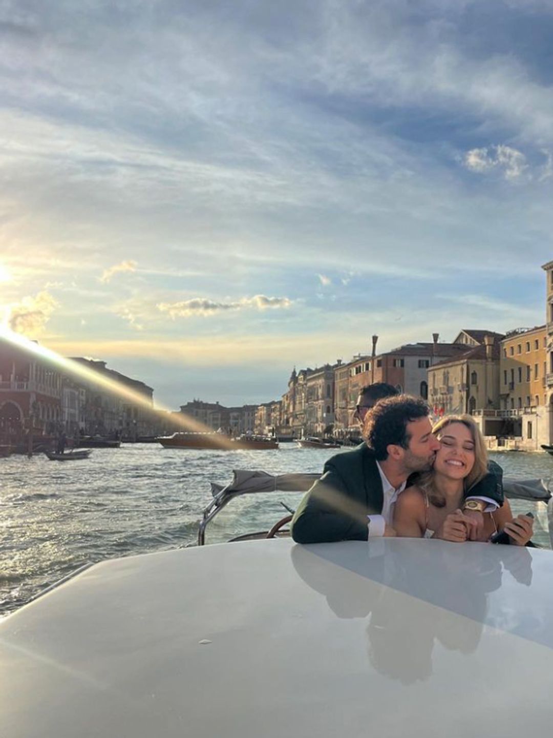 Daniel Ricciardo and Heidi Berger on a boat, with Daniel kissing her