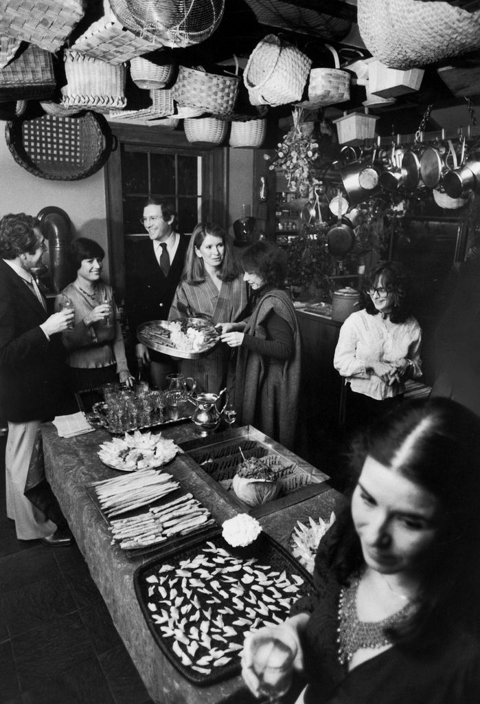 Martha Stewart and husband, publisher Andy Stewart entertaining dinner guests in restored kitchen of home, March 24, 1980