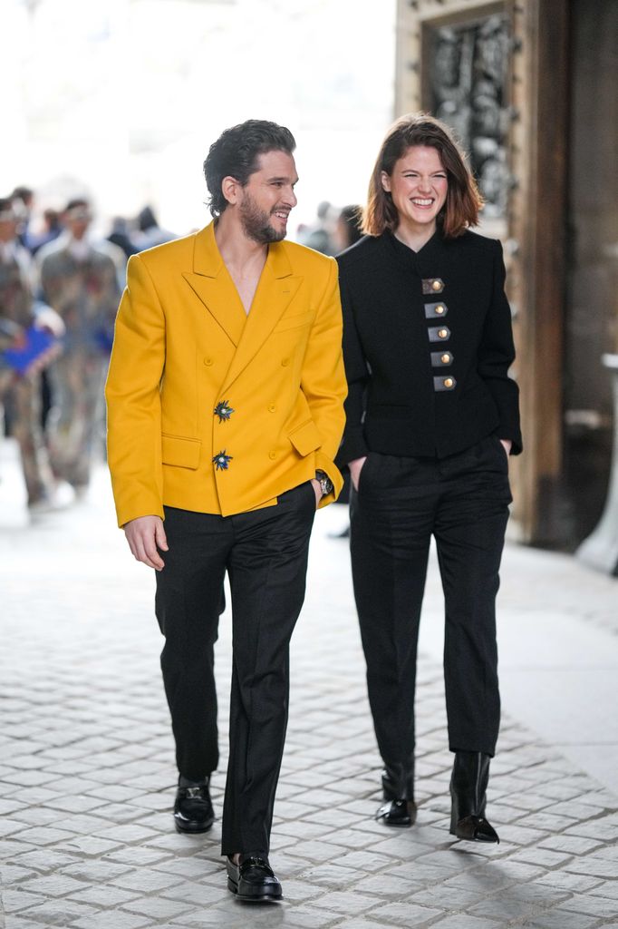 Kit Harington in a yellow jacket and Rose Leslie in a black outfit