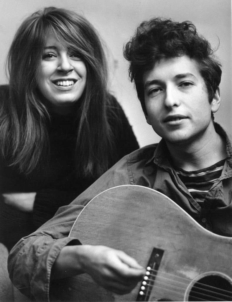 Bob Dylan holding his acoustic guitar and his girlfriend Suze Rotolo pose for a portrait in September 1961 in New York City, New York.