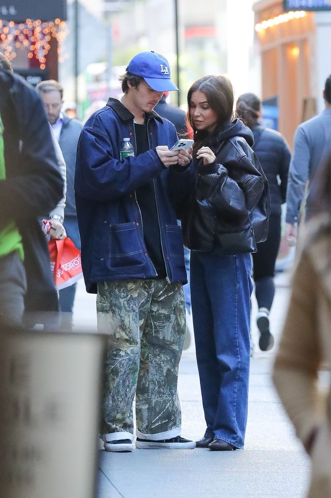 - Cruz Beckham and Jackie Apostel looking at their phone in new york