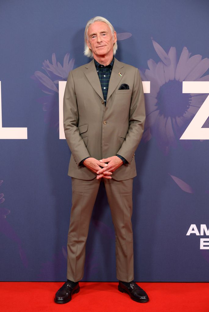 man posing on red carpet in suit 