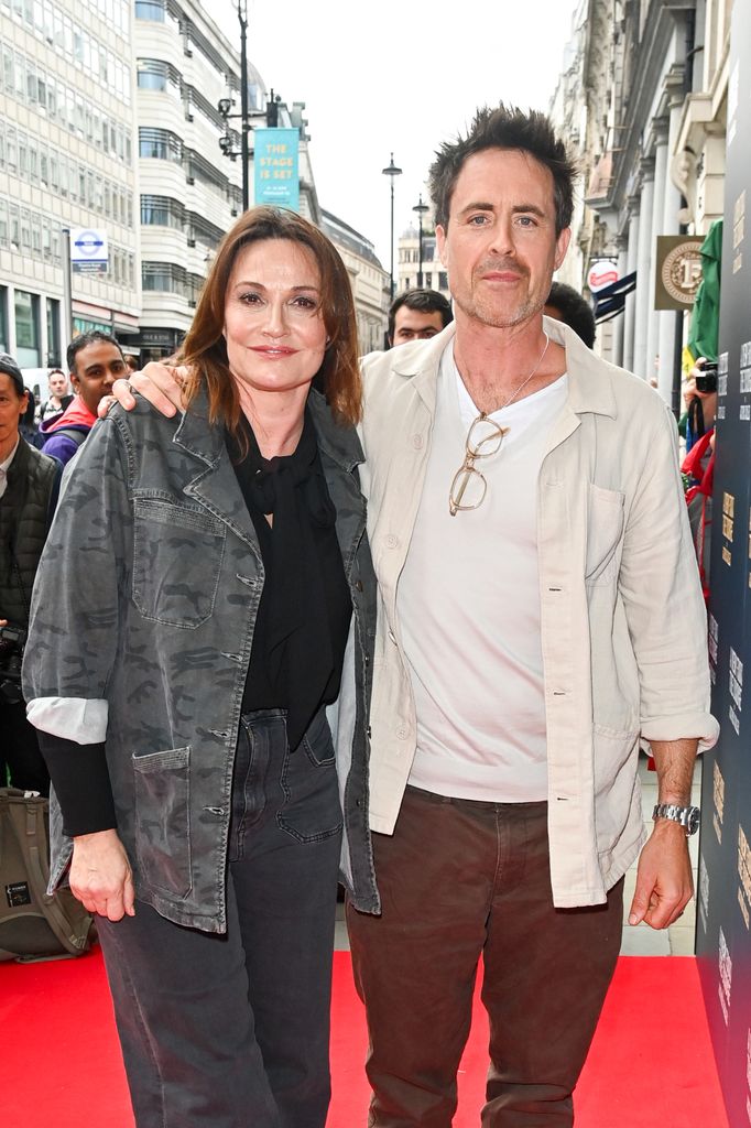 Sarah Parish standing with husband James Murray in front of a crowd of people