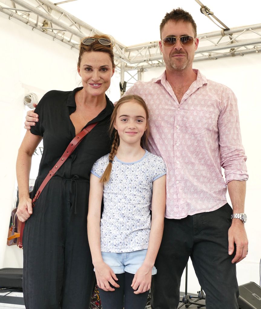 Sarah Parish standing with James Murray and their daughter Nell