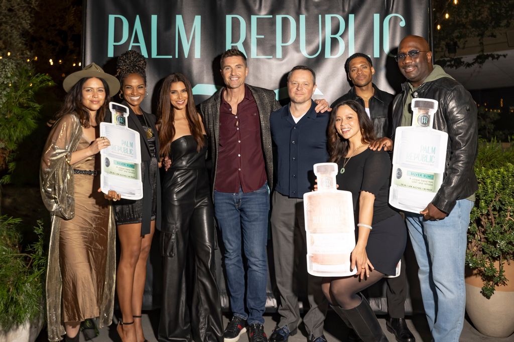 Eric Winter supported by Roselyn Sanchez and his The Rookie co-stars at Palm Republic event