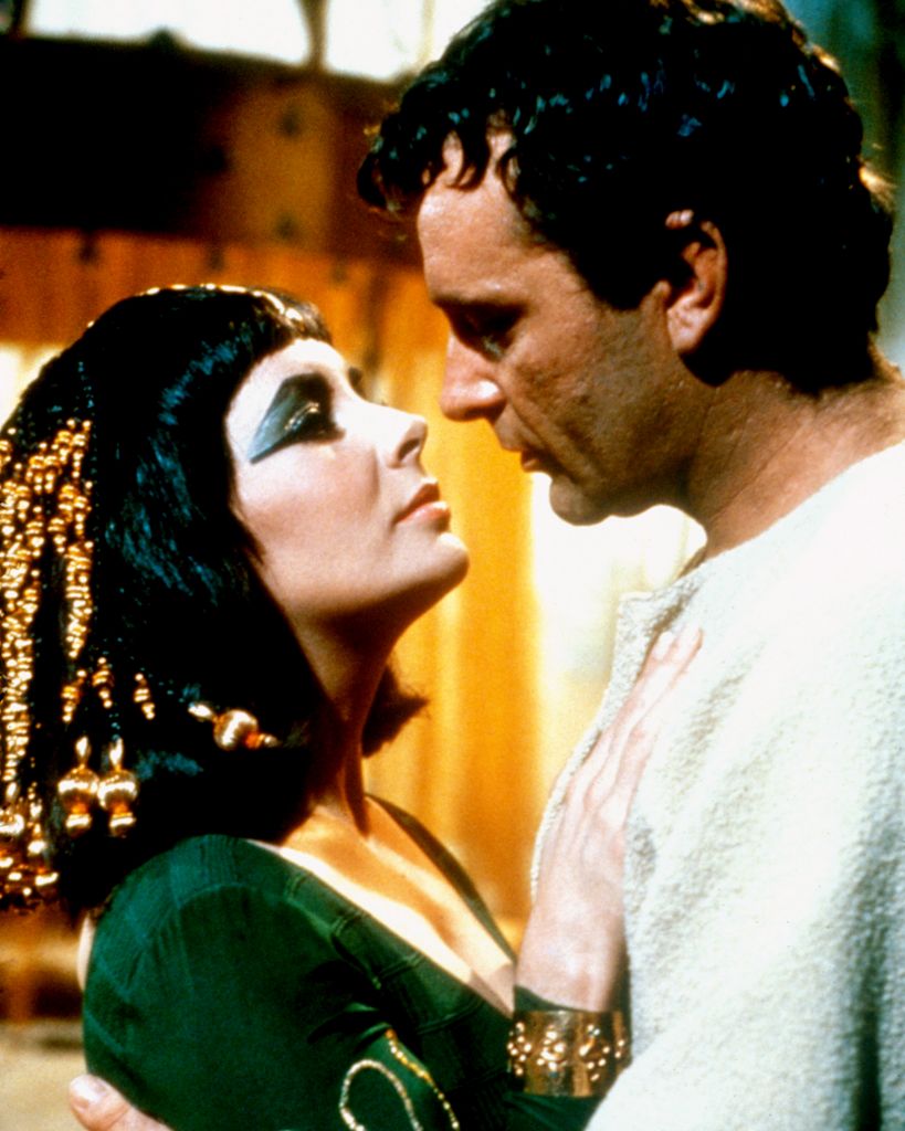 Elizabeth Taylor and Richard Burton about to kiss in character on the set of Cleopatra