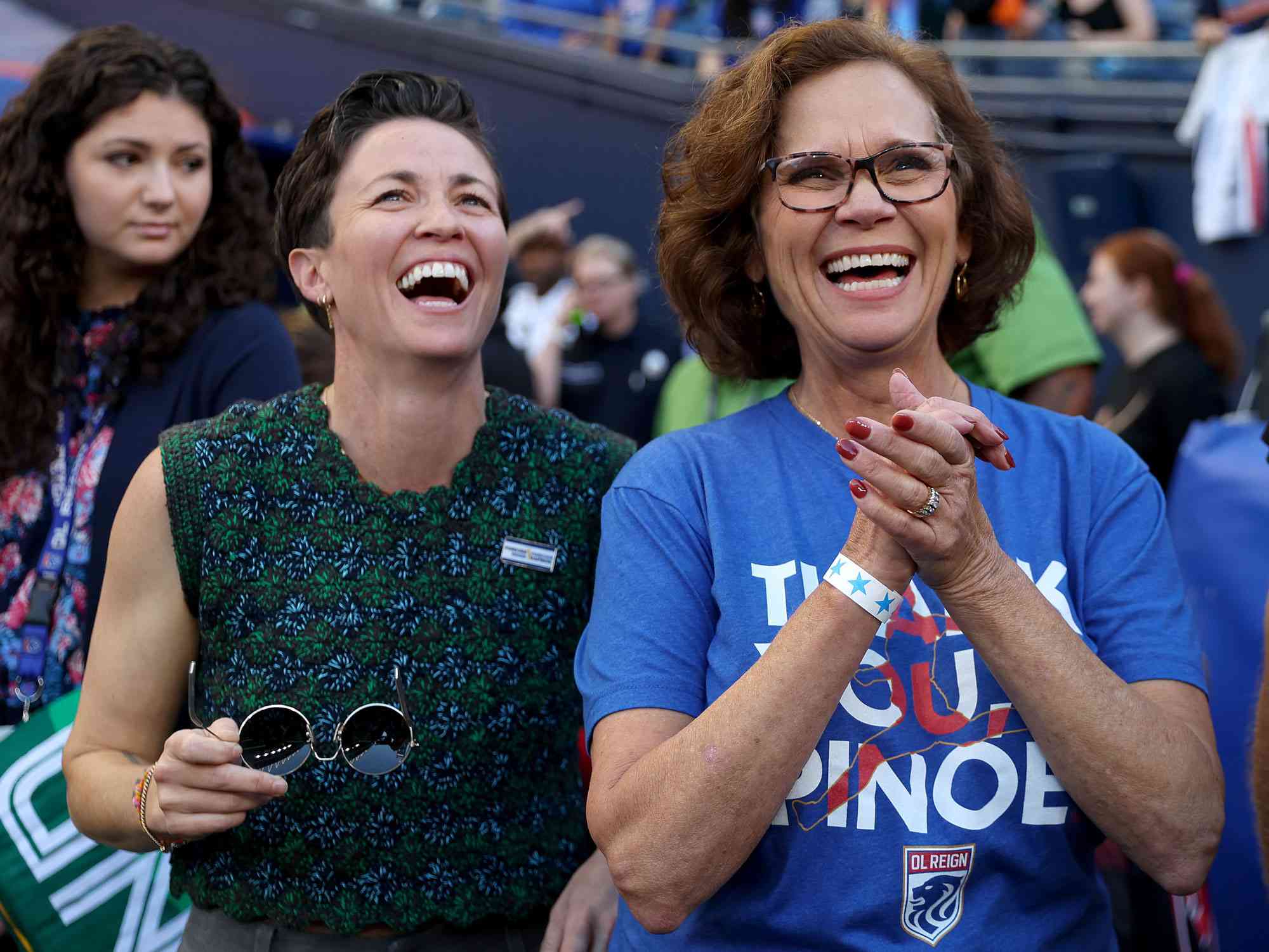 SEATTLE, WASHINGTON - OCTOBER 06: Denise Rapinoe, Megan Rapinoe #15 of OL Reign's mom, and her twin sister Rachael look on as they honor Megan Rapinoe #15 of OL Reign during her last home regular-season NWSL match at Lumen Field on October 06, 2023 in Seattle, Washington. (Photo by Steph Chambers/Getty Images)