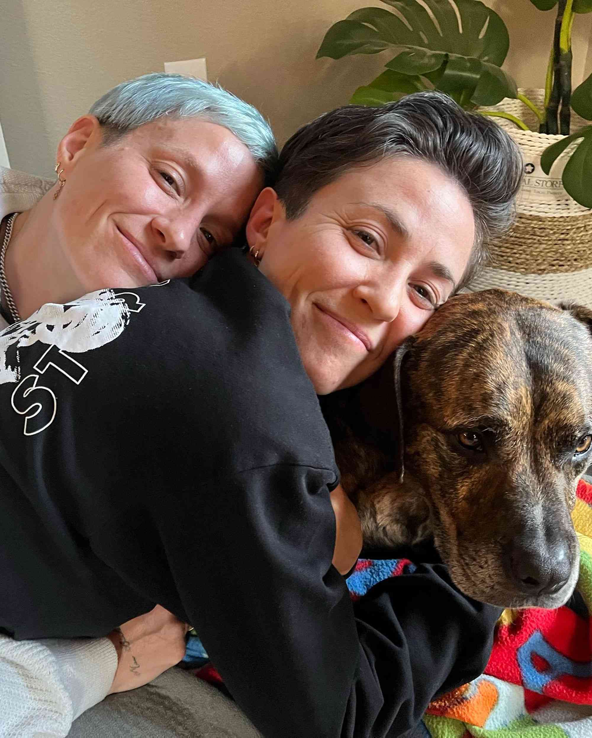 Rachael Rapinoe with her twin sister and dog.