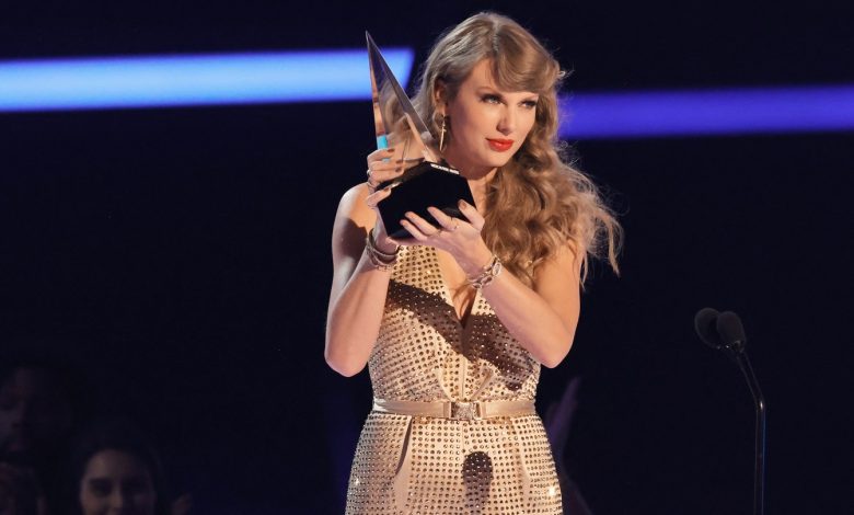 Taylor Swift accepts the Artist of the Year award during the 2022 American Music Awards in Los Angeles, California.