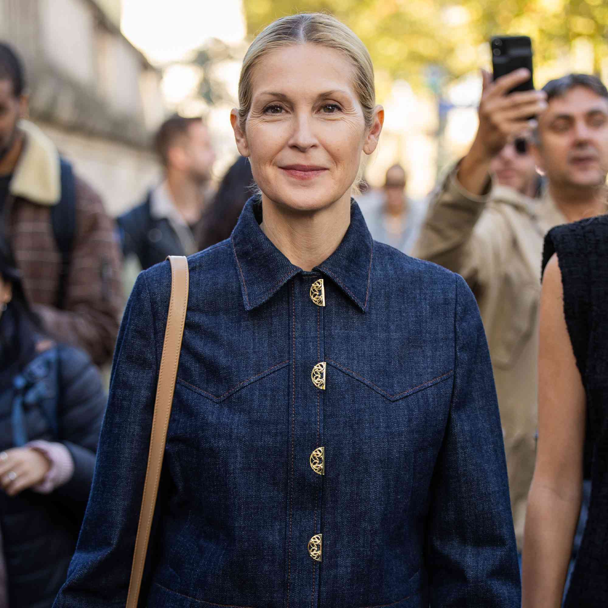 Kelly Rutherford wears navy jeans jacket, jeans, brown bag outside Elie Saab during Womenswear Spring/Summer 2025