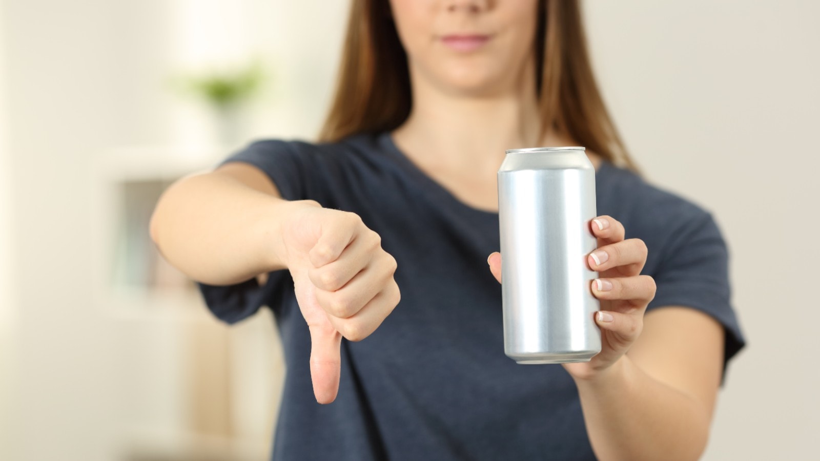 A woman saying no to aerated drinks to avoid acid reflux