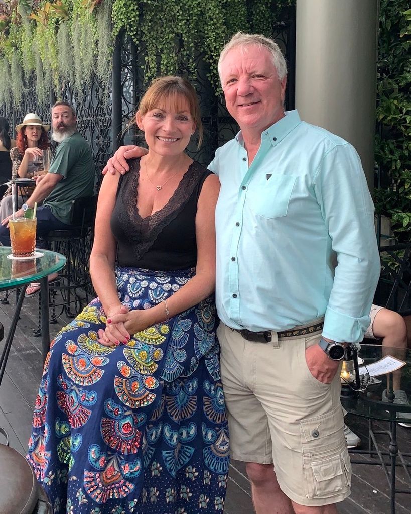 couple posing at outdoor bar