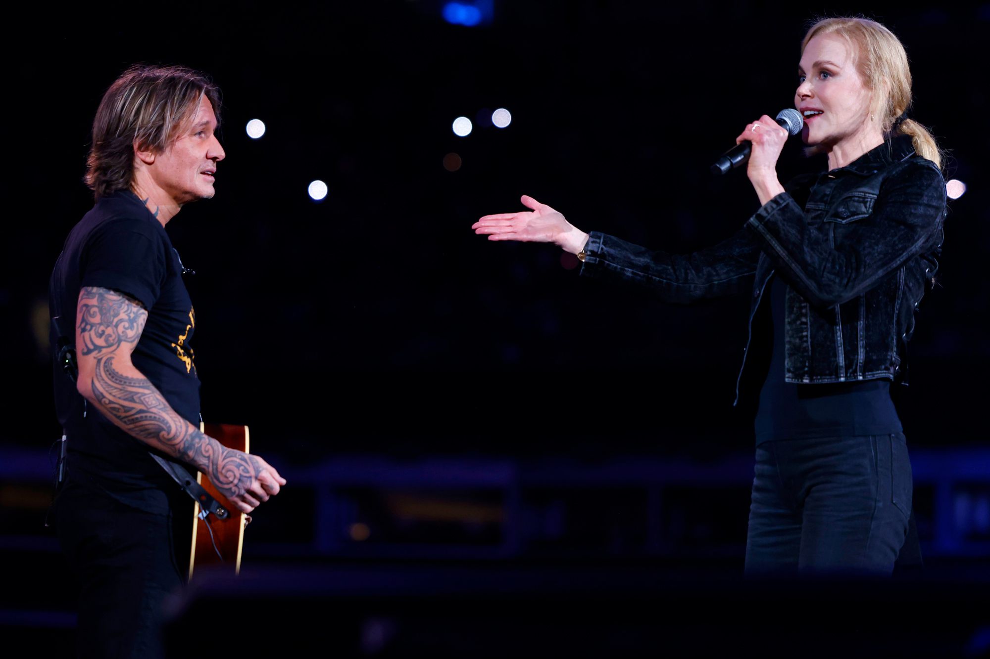 Keith Urban and Nicole Kidman speak onstage at the Concert For Carolina Benefit Concert at Bank of America Stadium on October 26, 2024 in Charlotte, North Carolina. 