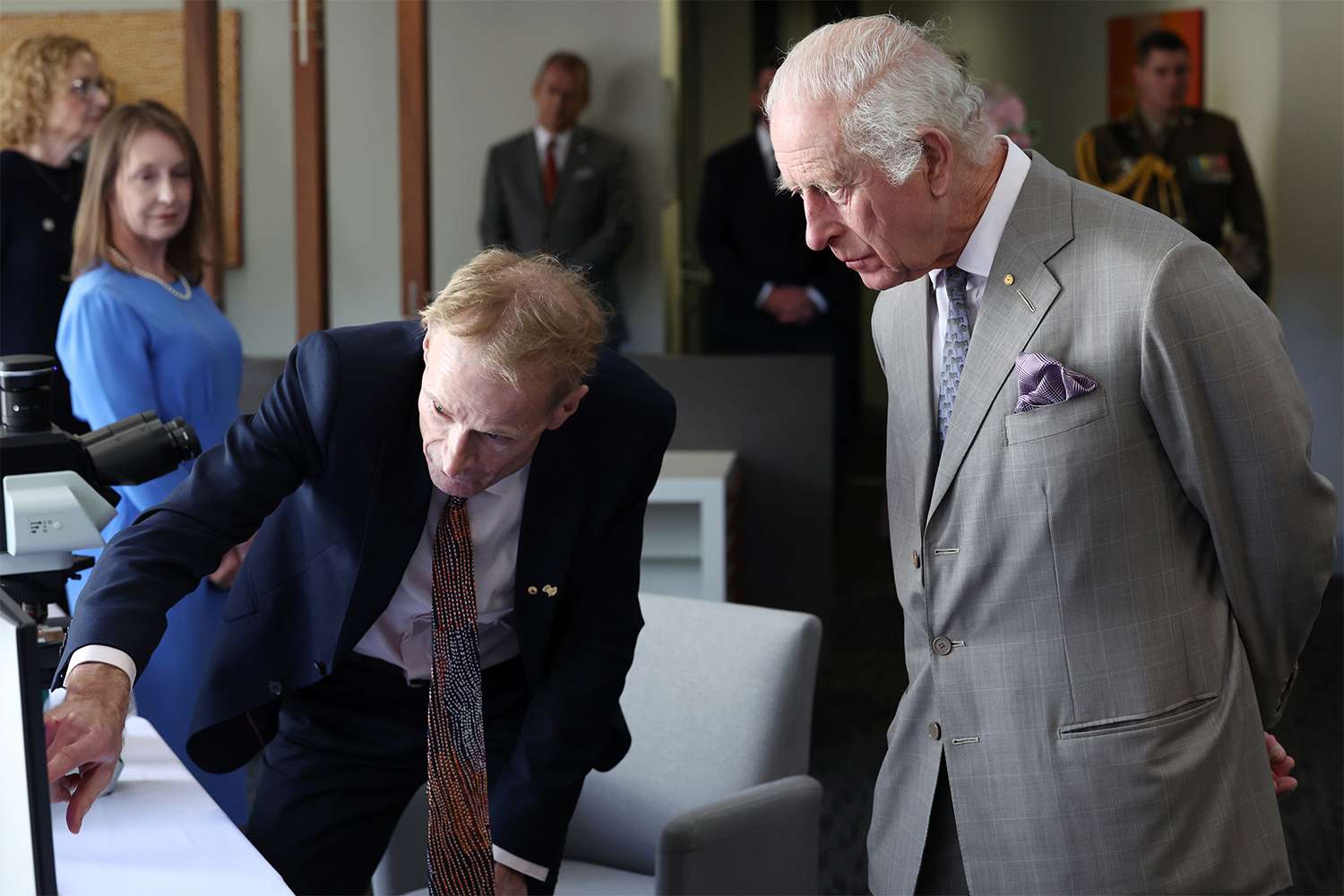 King Charles III (R) is briefed by co-medical director Richard Scolyer during a visit to the Melanoma Institute of Australia on October 22, 2024 in Sydney, Australia.