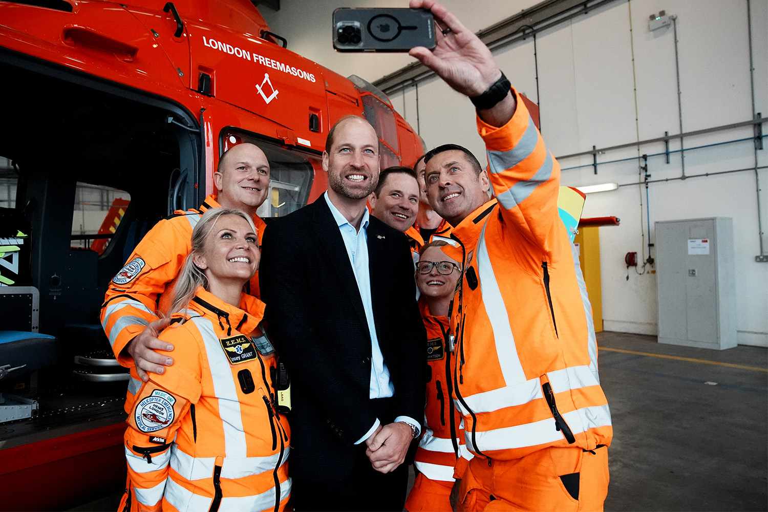 Prince William, Prince of Wales meets with staff and crew members during a visit to the London Air Ambulance overnight airbase at RAF Northolt in west London