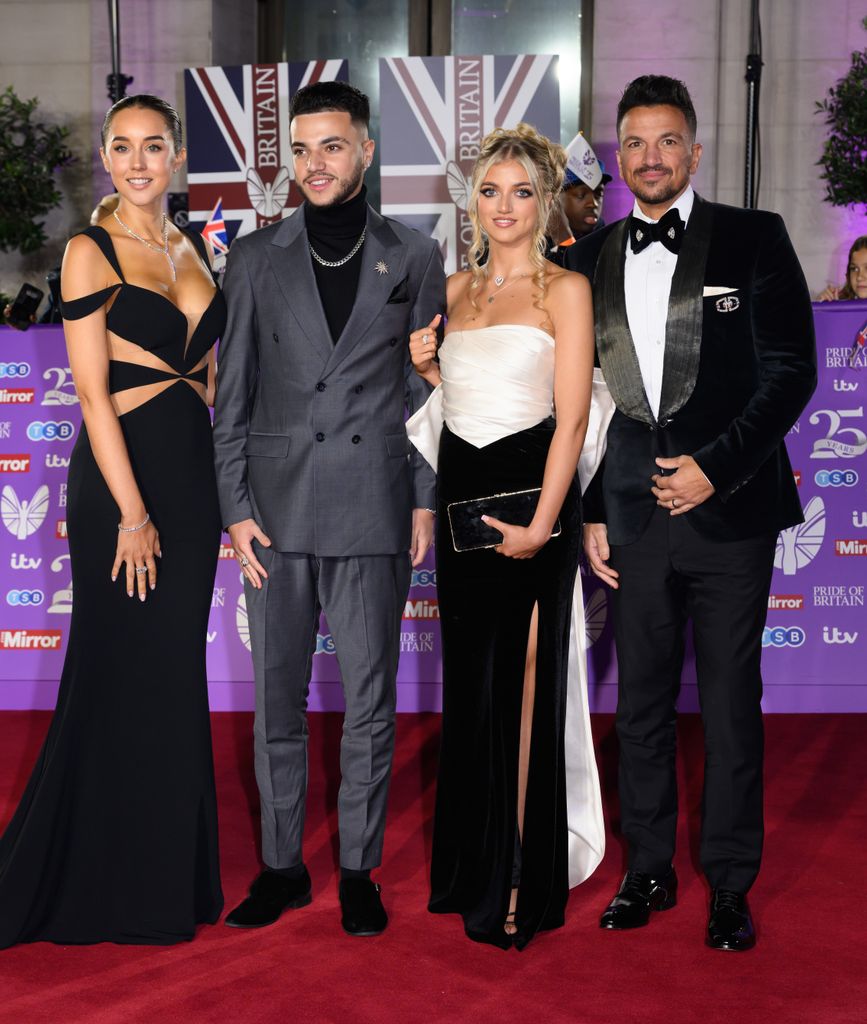 family posing on red carpet 