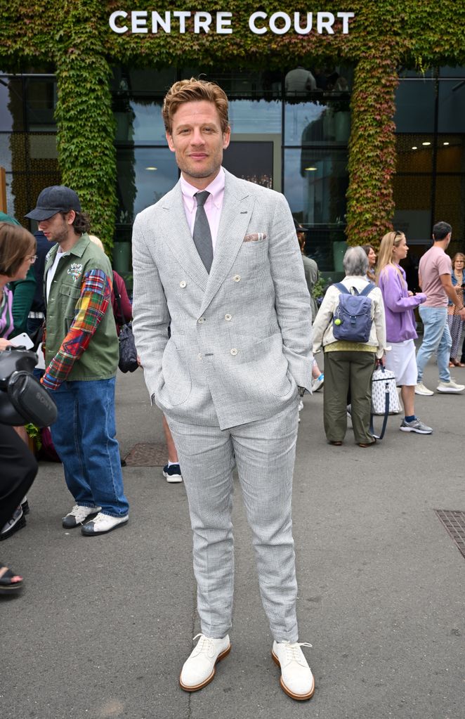 man in suit at tennis competition