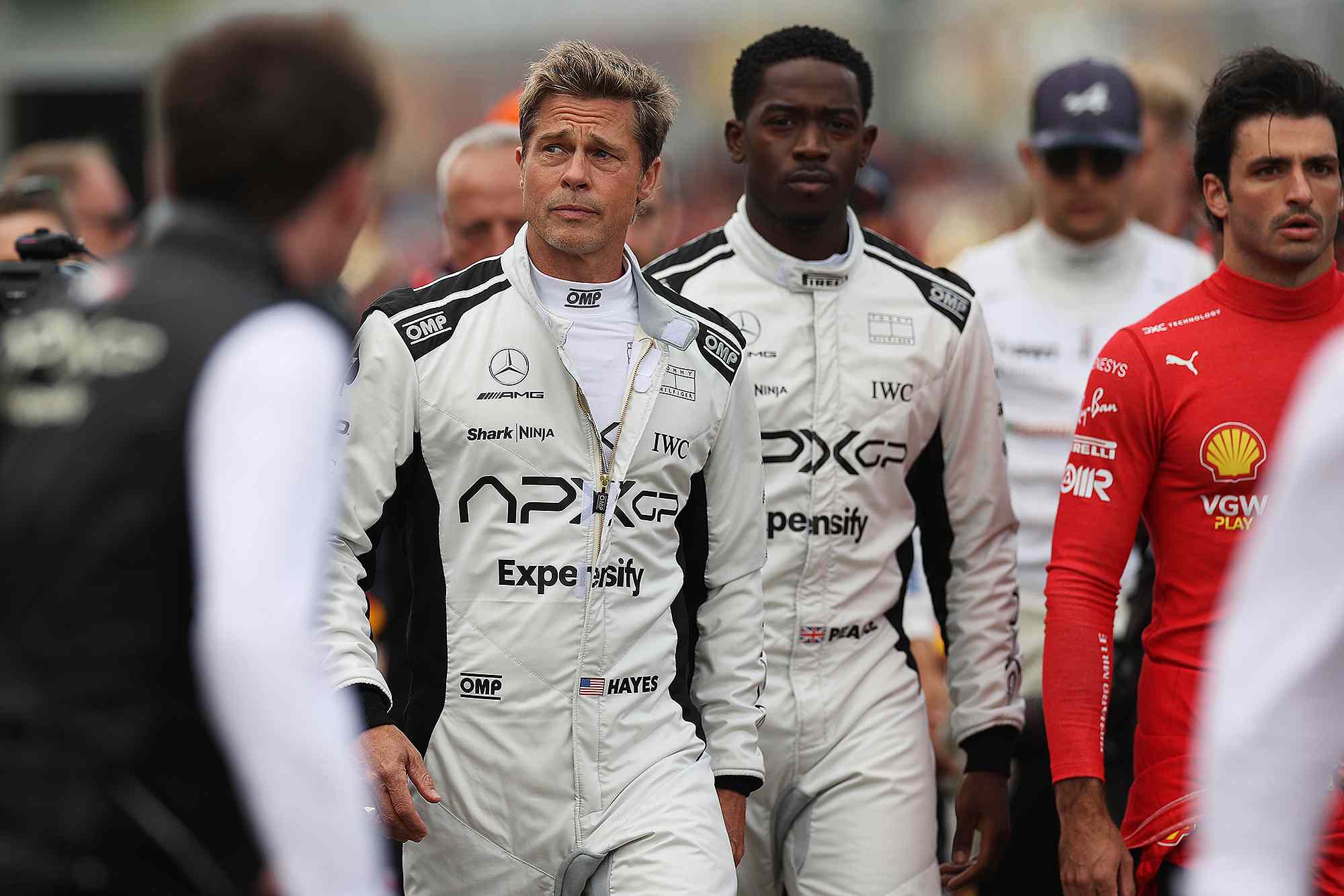 NORTHAMPTON, ENGLAND - JULY 09: Brad Pitt, star of the upcoming Formula One based movie, Apex, and Damson Idris, co-star of the upcoming Formula One based movie, Apex, walk on the grid during the F1 Grand Prix of Great Britain at Silverstone Circuit on July 09, 2023 in Northampton, England.