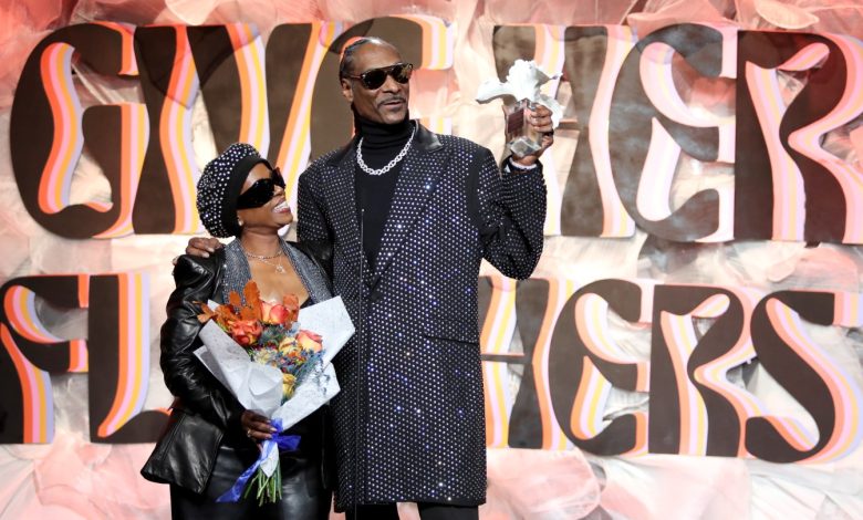 Shante Broadus and Snoop Dogg accept an award onstage at the 2024 Give Her FlowHers presented by Live Nation at The Beverly Hilton on Nov. 8.