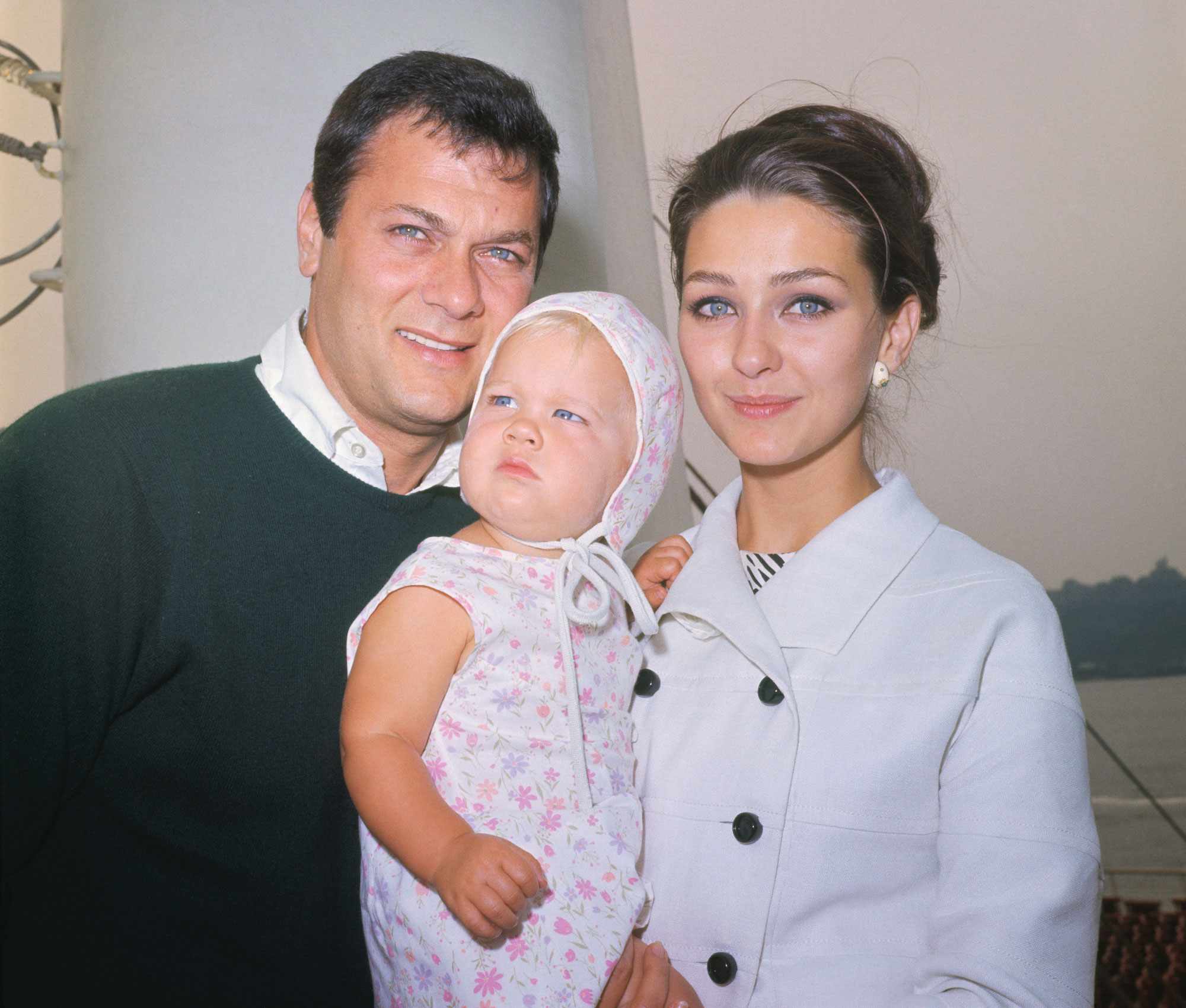 (Original Caption) New York. Actor Tony Curtis, his actress wife Christine Kaufmann and their one year old girl Alexandra leave New York aboard the France August 5. The trio is Europe-Bound where Curtis will film his latest movie, , My last Duchess.