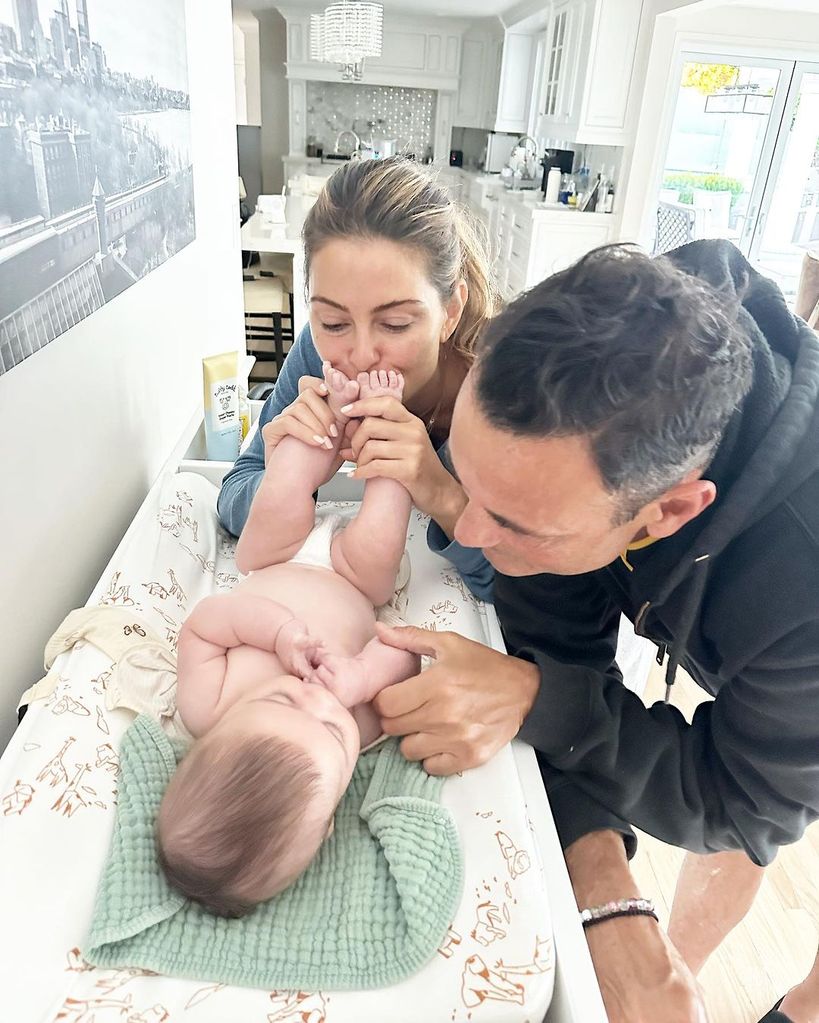 Maria Menounos and Keven Undergaro cozy up to baby Athena