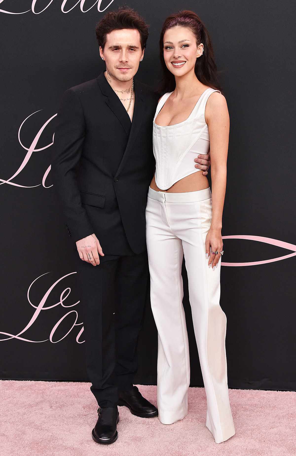 Former British model Brooklyn Beckham (L) and wife US actress Nicola Peltz Beckham arrive for the premiere of the movie "Lola" at the Bruin Theatre, in Los Angeles, California on February 3, 2024. 