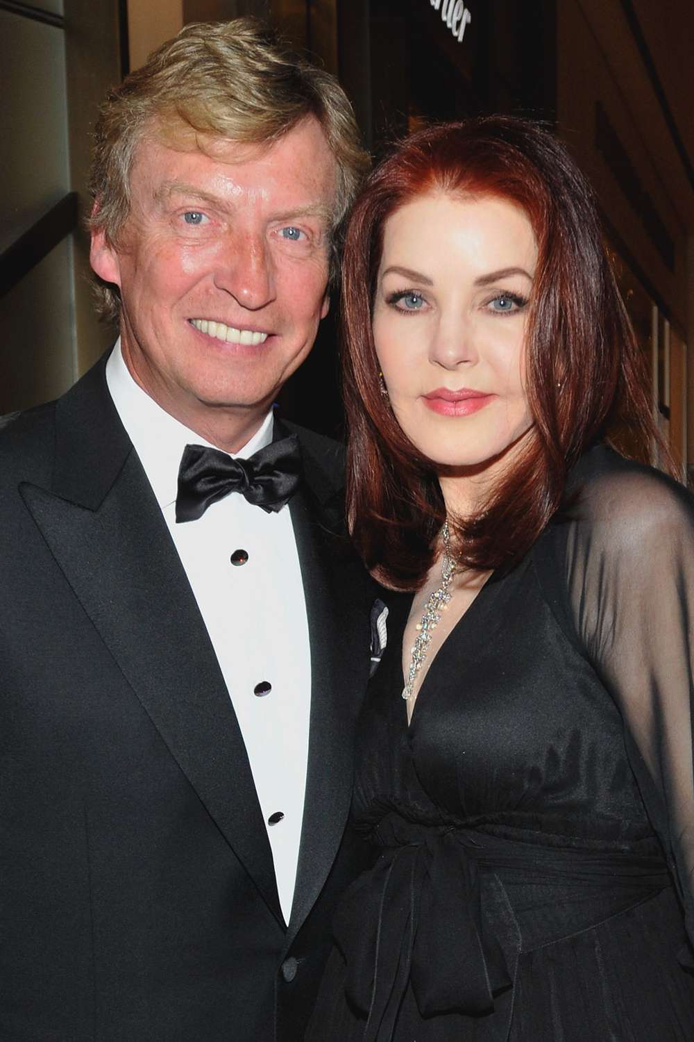 Nigel Lythgoe and Priscilla Presley appear at a cocktail reception at Cartier inside Crystals at CityCenter prior to the annual Black & White Ball fund-raising event for the Nevada Ballet Theatre on January 29, 2011 in Las Vegas, Nevada.