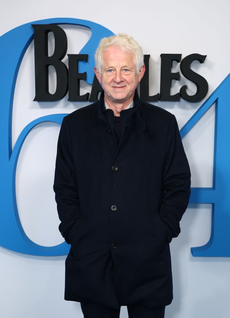 Richard Curtis in a black coat