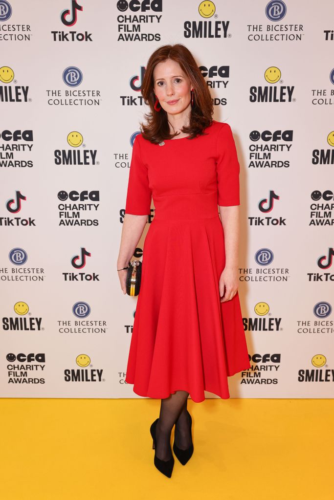 actress on yellow carpet in red dress 