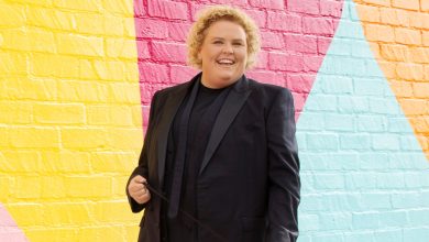 Fortune Feimster poses against a colorful backdrop.