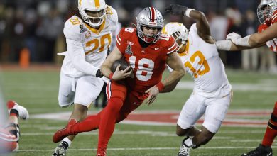 Ohio State Buckeyes quarterback Will Howard (18) runs with the ball ahead of Tennessee Volunteers defensive lineman Bryson Eason (20) and linebacker Edwin Spillman (13) during the CFP First Round game on December 21, 2024 at Ohio Stadium in Columbus, Ohio.