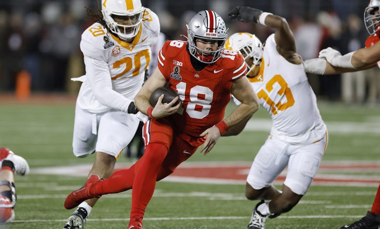 Ohio State Buckeyes quarterback Will Howard (18) runs with the ball ahead of Tennessee Volunteers defensive lineman Bryson Eason (20) and linebacker Edwin Spillman (13) during the CFP First Round game on December 21, 2024 at Ohio Stadium in Columbus, Ohio.