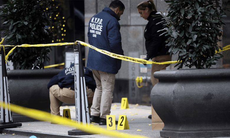 Police place bullet casing markers outside of a Hilton Hotel in Midtown Manhattan where United Healthcare CEO Brian Thompson was fatally shot on Dec. 4, 2024, in New York City.