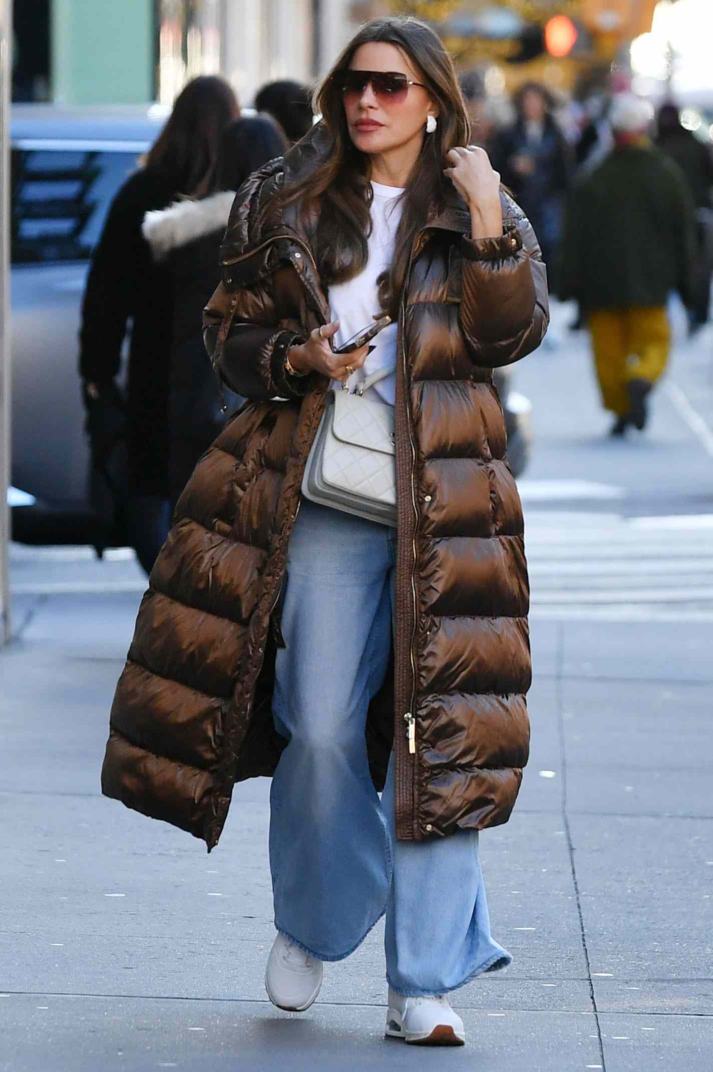 Sofia Vergara is spotted shopping on the Upper East Side in New York City. The 52 year old actress carried a Chanel bag and wore a long puffer jacket, white sweater, jeans, and white trainers. The sighting comes after she recently confirmed she is single.