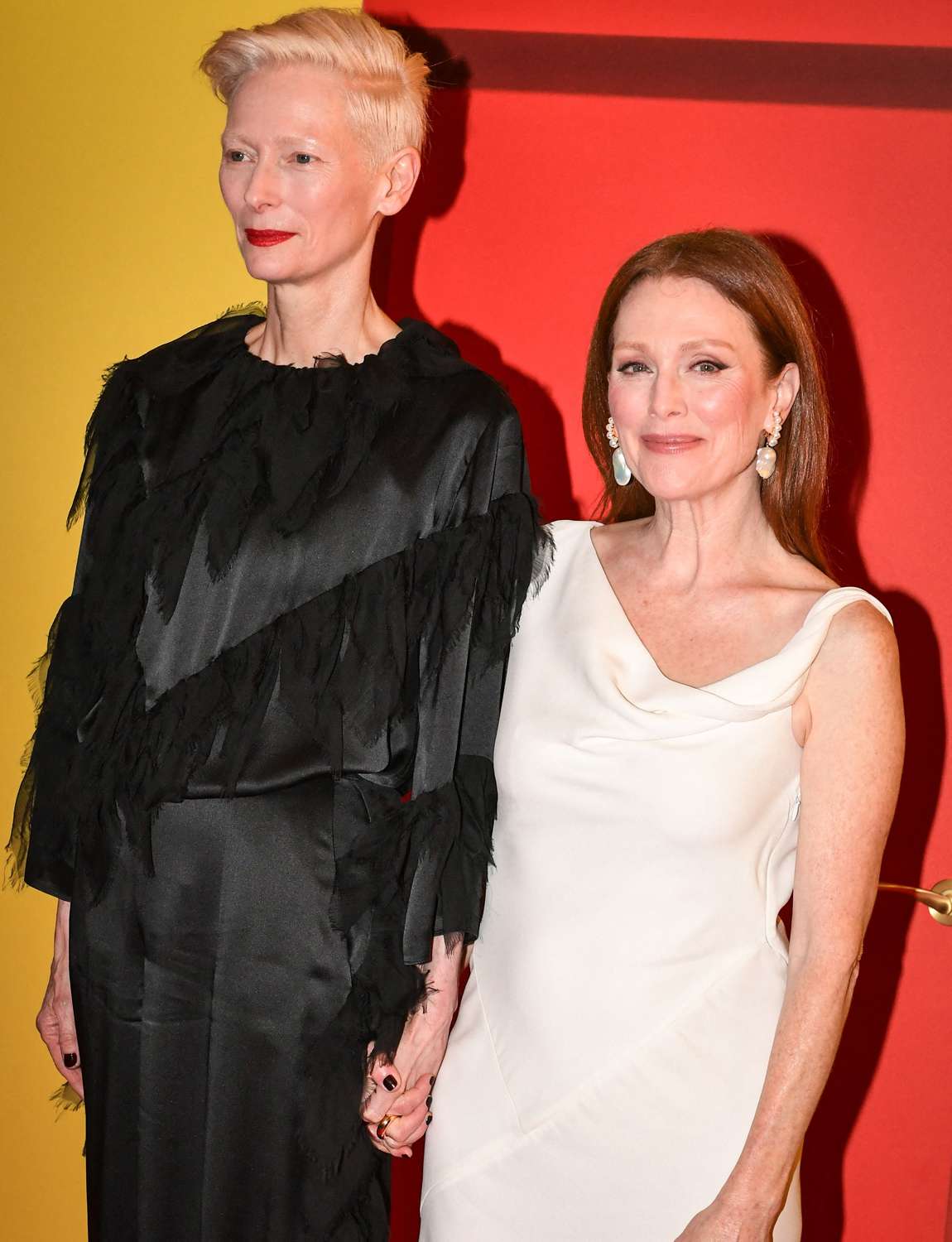 Tilda Swinton poses next to American actress Julianne Moore for a photo-call for the film La Chambre d'a cote at the Pathe Cinema in Paris, on December 16, 2024.