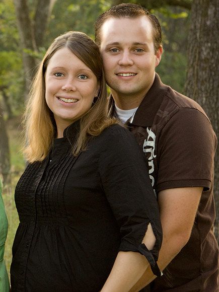 Anna and Josh Duggar smile together.