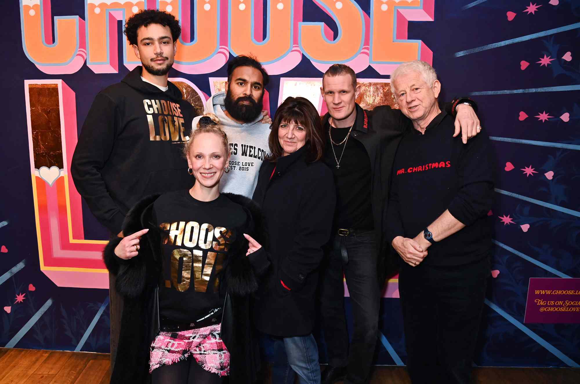 (L to R) Archie Madekwe, Juno Temple, Himesh Patel, Emma Freud, Matt Smith and Richard Curtis pose at the Choose Love 2024 pop-up shop on Regent Street on December 19, 2024 in London, England.