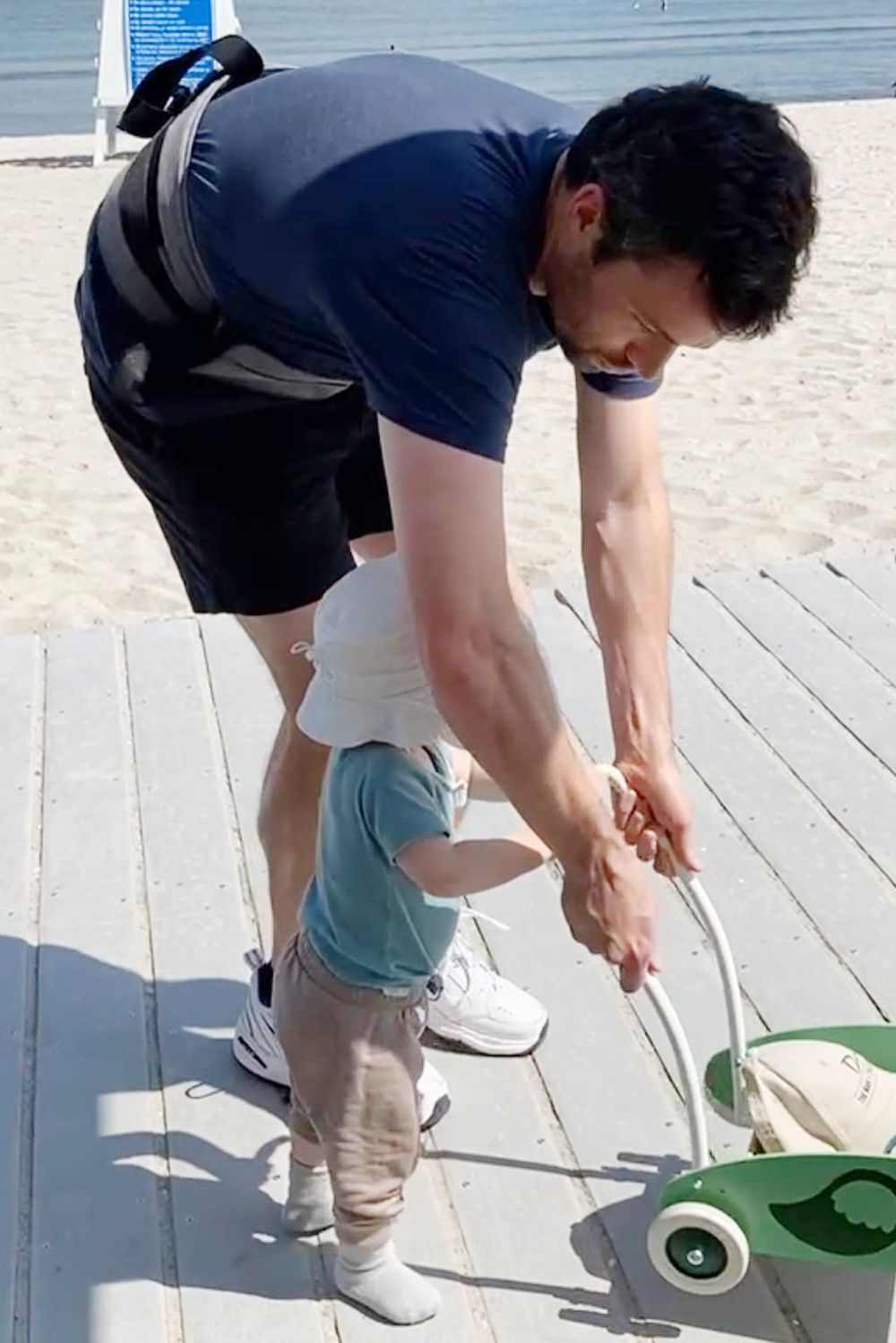 Ian Harding with his son on the beach.