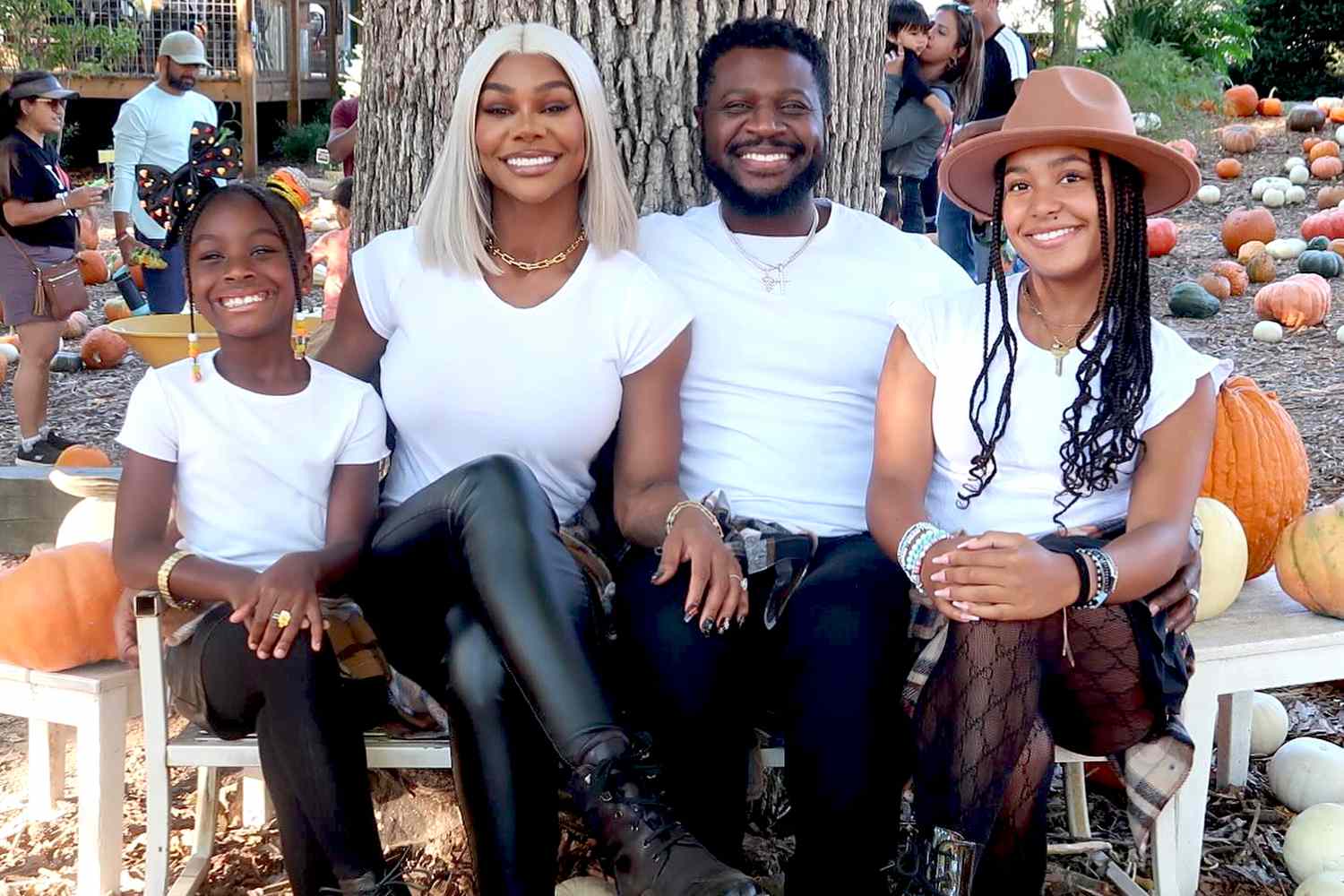 Jade Cargill and Brandon Phillips smile at a pumpkin patch with their two daughters Bailey and Micole.