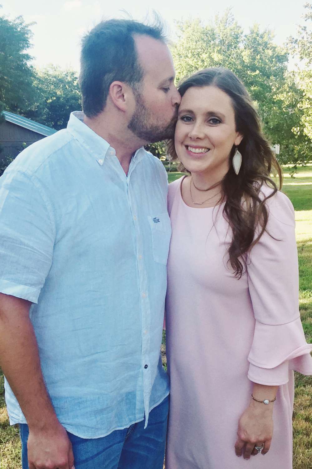 Josh Duggar kisses wife Anna Duggar.