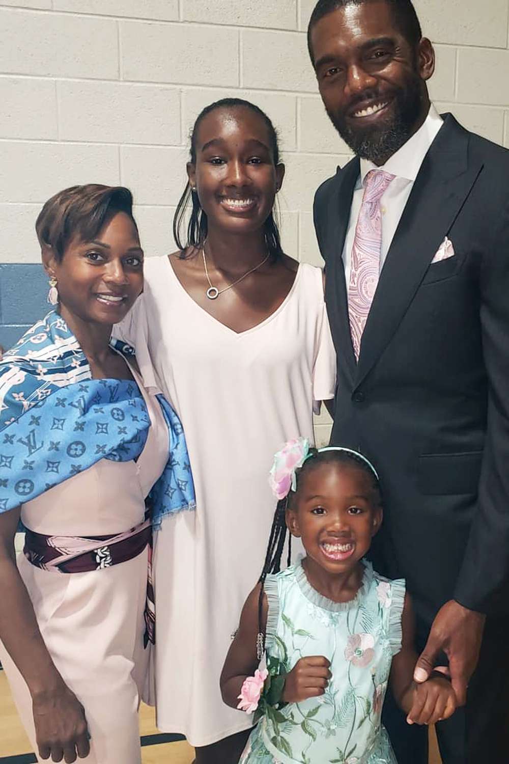 Randy Moss smiles with his family.