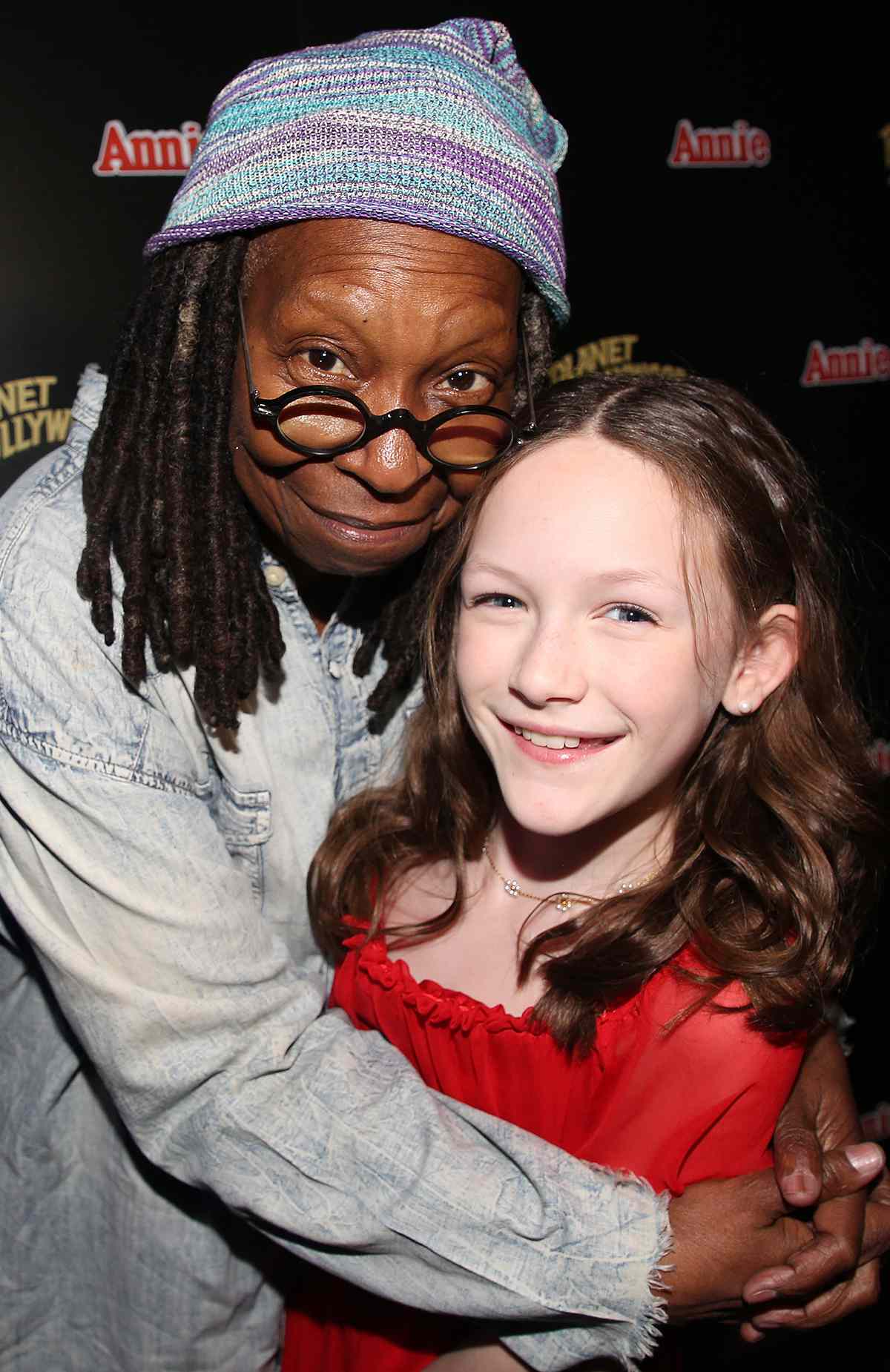 Whoopi Goldberg and Hazel Vogel pose as Planet Hollywood New York City hosts Whoopi Goldberg & the cast of Madison Square Garden's "Annie" opening night celebration