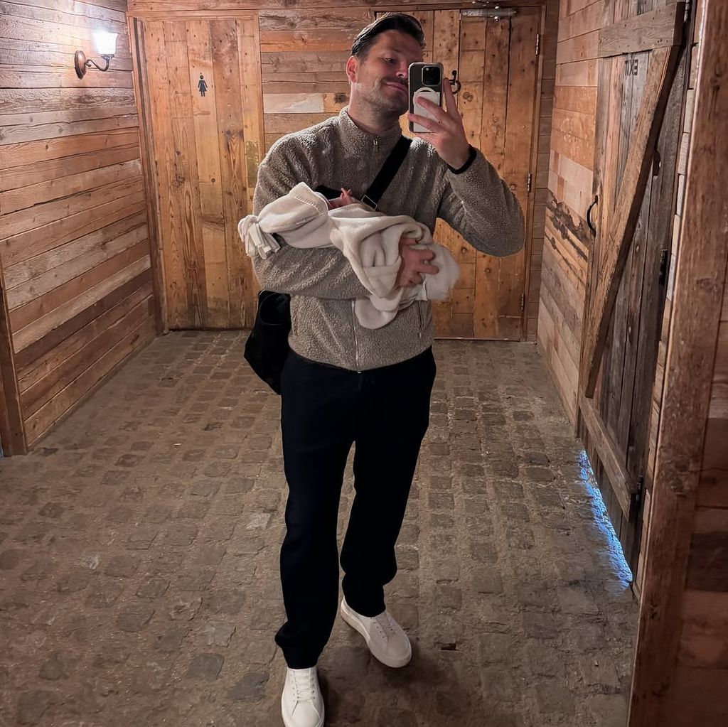 Mark Wright holds his baby daughter